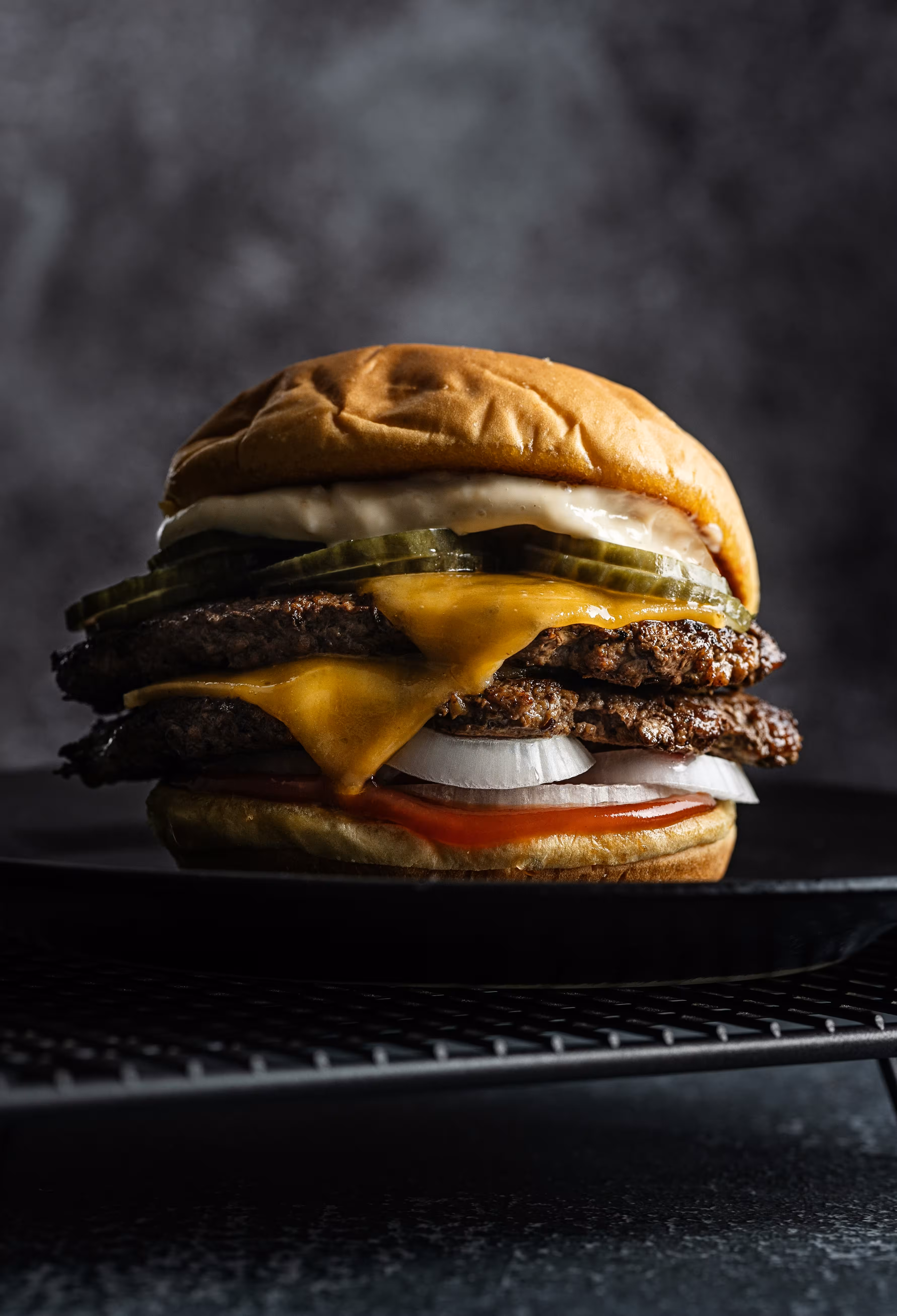 The Oak Smash: two patties under melted cheese, with pickles and white onion in a brioche bun.